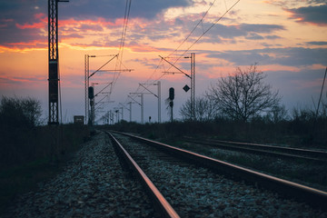 Fototapeta na wymiar Sunset on the railroad tracks landscape.