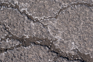 Pavement With Cracks and Salt Deposits