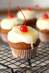 Vanilla cupcake with butter cream frosting and lemon curd  with cherry on top. Candy bar for celebrating partys and birthdays