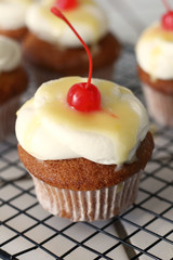 Homemade bakery style vanilla delicious sponge cake with white cream frosting and yellow lemon syrup curd  with cherry on top. Candy bar for celebrating partys and birthdays