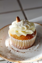 Homemade bakery style vanilla delicious sponge cake with white butter cream cream frosting and almond on top on plate. Candy bar for celebrating partys and birthdays