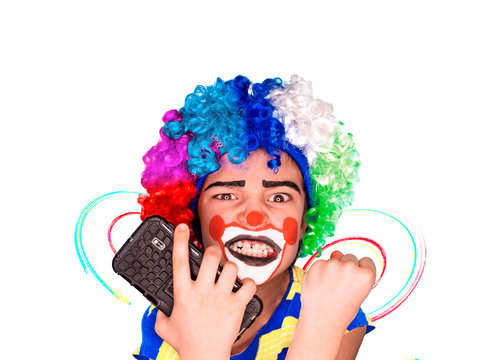 Portrait of happy funny clown kid holding smartphone and angry because of bad news. Negative and expression concept.pantomimic expression. emotions. April Fool's Day, April 1. Isolated on white.