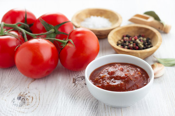 Tomato sauce in a white bowl on a table