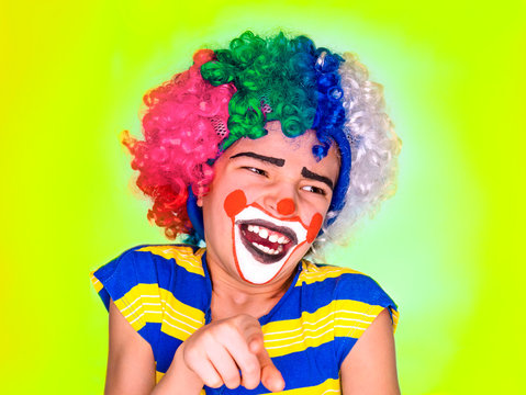Handsome little boy Laughs and Points Finger. little cute boy with facepaint like clown, pantomimic expression. emotions. April Fool's Day, April 1