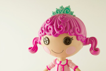 Beautiful doll with pink hair isolated on white background. Girl doll toy isolated.