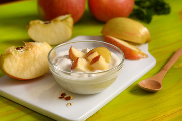 apple yogurt in the glass bowl with fruit around - closeup