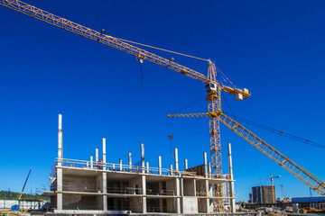 Panorama of the construction site. Construction crane. Construction of the building. Pouring cement. Walling.