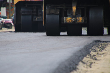 Road construction asphalt road by worker and roller machine. Asphalt road background