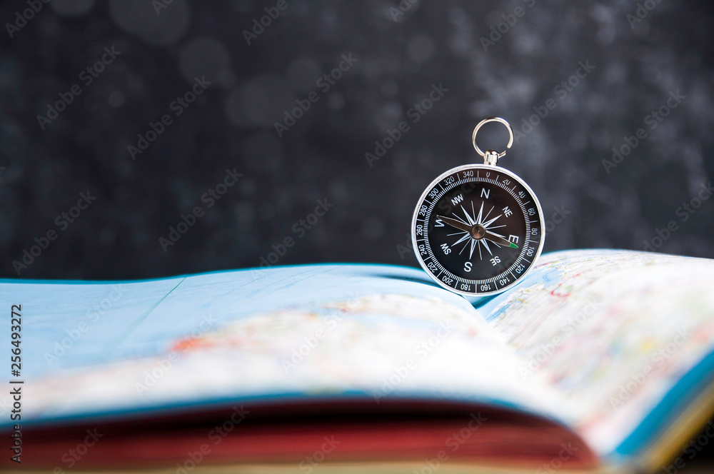 Wall mural old compass and map on a dark background. copy space for text or design