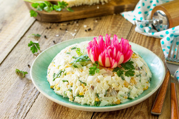 Festive snack on Easter table. Salad with Rice, Onion, Egg, Corn and Mushrooms on table.