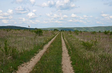 Fototapeta premium Huge sheer stone cliffs on the background of a river Dniester and a blue sky with clouds