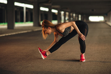 Young woman stretching before running