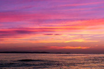 Naklejka na ściany i meble Beautiful yellow purple red sky at sunset over the sea