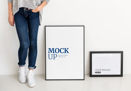 Person Standing Next to 2 Frames Mockup