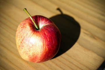 Red apple on a wooden table