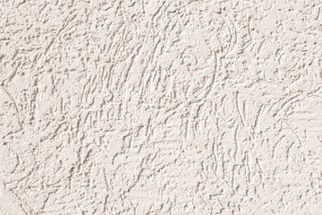 Photo of the concrete wall of the house with rubbing. Sunny day. Texture background