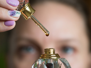 A drop of perfume on a glass stick.