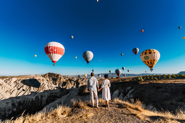 Couple in love among balloons. Loving couple rear view. Couple in love in Cappadocia. Couple in...