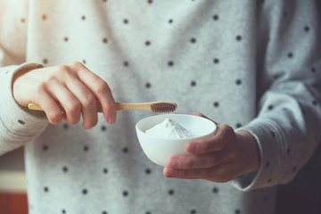 plastic less, zero waste concept, woman holding eco-friendly bamboo toothbrush and natural...