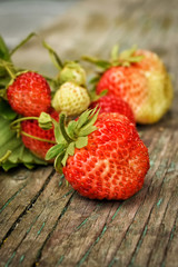 red strawberries on wooden background, harvest