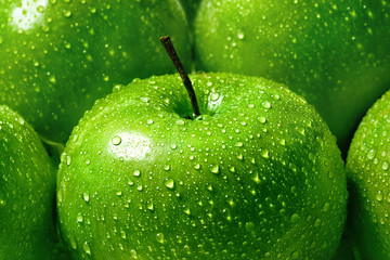 green apple with water drops close-up macro, background