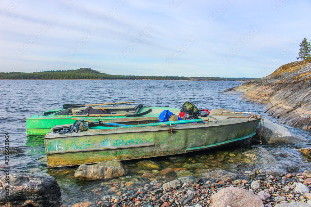 Wall mural two boats at the rocky shore