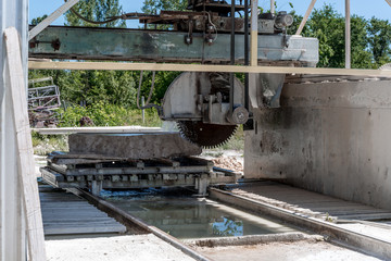 Machine cutting a granite block.