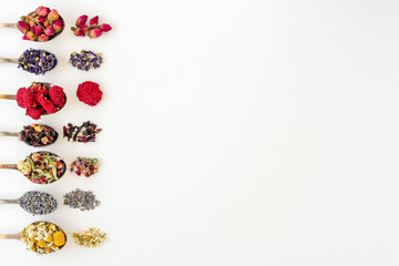 Variety of tea in  spoons, isolated on white