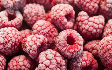 Red frozen frosted raspberries.