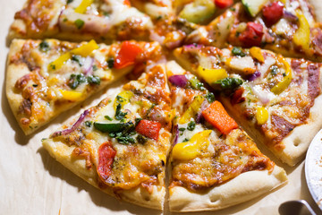 Pizza with grilled vegetables: courgette, peppers, red onion & green pesto
