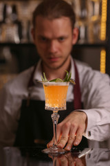 Bartender is making Pisco sour alcohol cocktail drink. Pisco sour cocktail drink with ice cubes