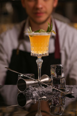 Bartender is making Pisco sour alcohol cocktail drink. Pisco sour cocktail drink with ice cubes