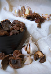 Fototapeta na wymiar dried mushrooms with garlic in a black Cup close-up