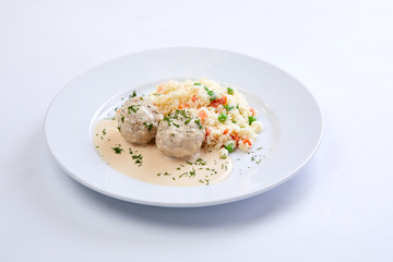 meatballs with rice and vegetables on the white background
