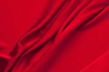 Fototapeta na wymiar Luxury red satin fabric cloth abstract background