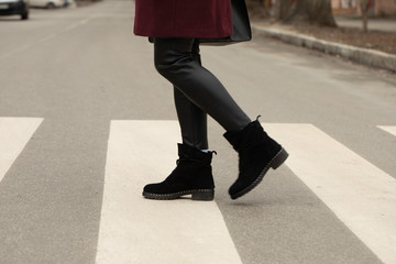 close up of woman legs walking on crosswalk