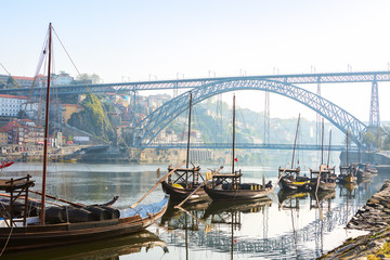 Traditional  boats in the morning on river Douro with Porto city in the background, Portugal.