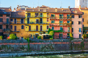 Colorful houses facades near the Adige river bank, Verona, Italy.