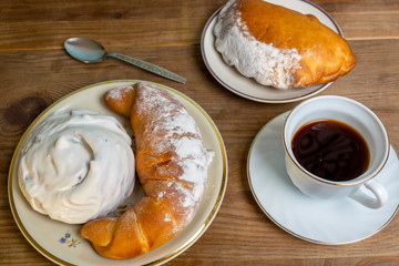 Sweet donut and bagel on a plate on wooden table