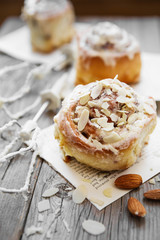 Sinnabon buns. Sinabon rolls with cream cheese and cream, chocolate and almond nuts