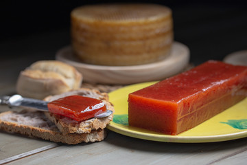 a cut of quincy jelly on a slice of bread with cheese