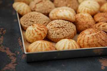 Homemade profiteroles on the music sheet with notes. Profiteroles (choux à la crème) - French choux pastry balls filled with custard or cottage cheese