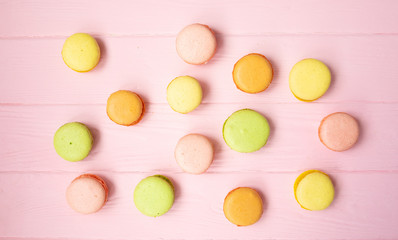Multicolored macaroons on pink background.
