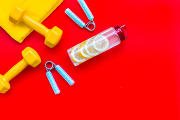 Naklejka premium Sport with bars, towel, water and wrist builder red background top view space for text