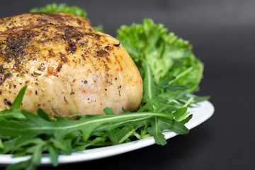 baked chicken breast with lettuce leavesbaked chicken breast with green lettuce and arugula