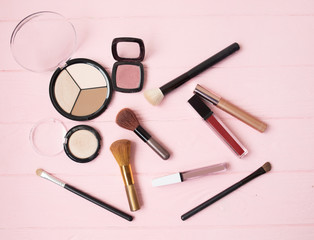 Makeup cosmetics, brushes and other essentials on white background. Top view, flat lay. Multicolored beauty tools and products collection, lipsticks, eyeshadow, mascara and more