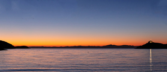 Fototapeta na wymiar Greece, Kea island. Seascape with lighthouse at sunset,