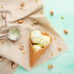 Pistachio ice cream with pistachio nuts and ice cream spoon, Top view, Flat lay.Summer mood