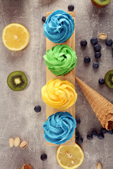 Vanilla frozen yogurt or colorful soft ice cream in waffle cone.