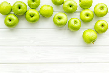 green apples for organic summer food pattern on light wooden background top view mockup